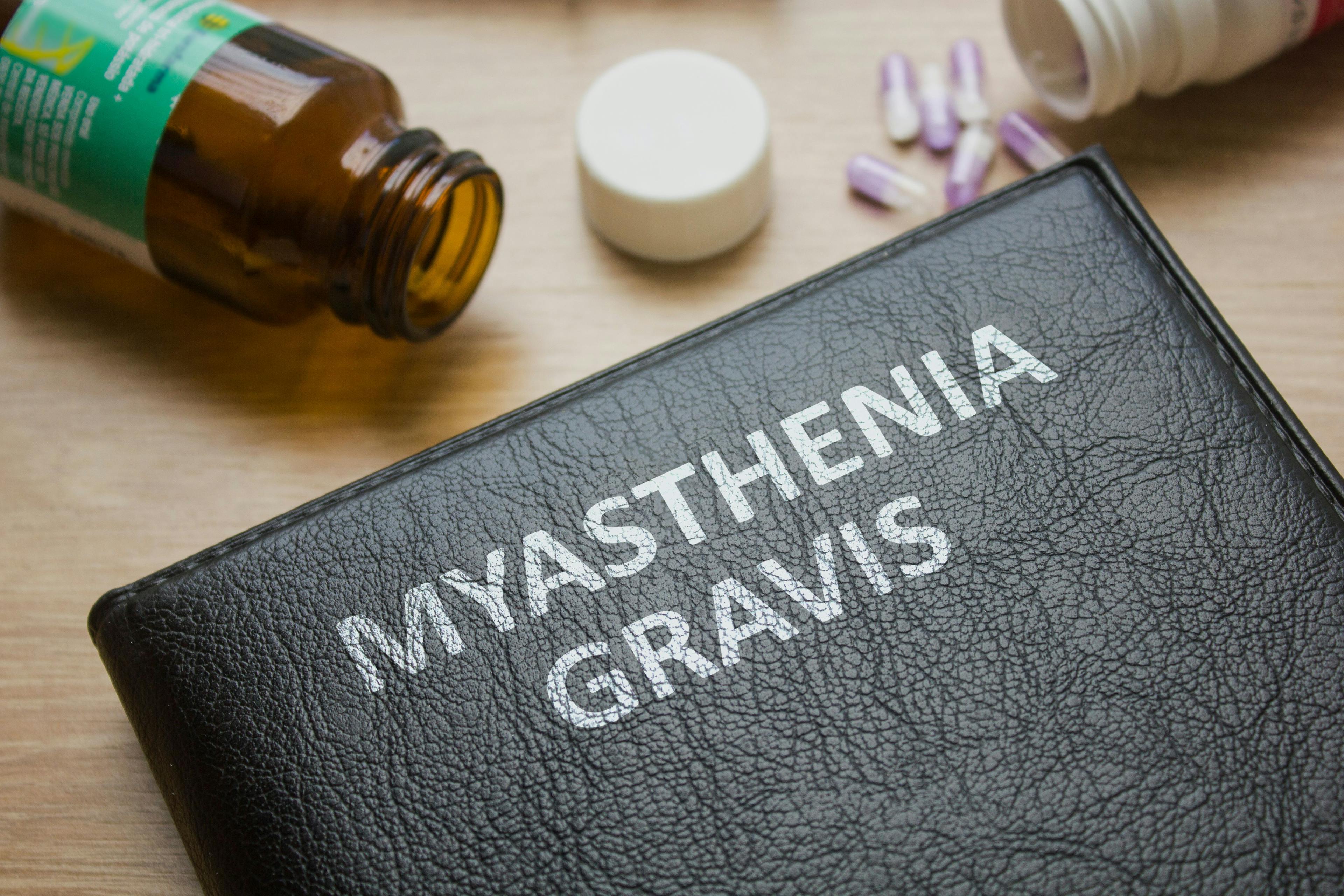 Book about Myasthenia gravis and medication, injection, syringe and pills:Black book  © mdaros - stock.adobe.com