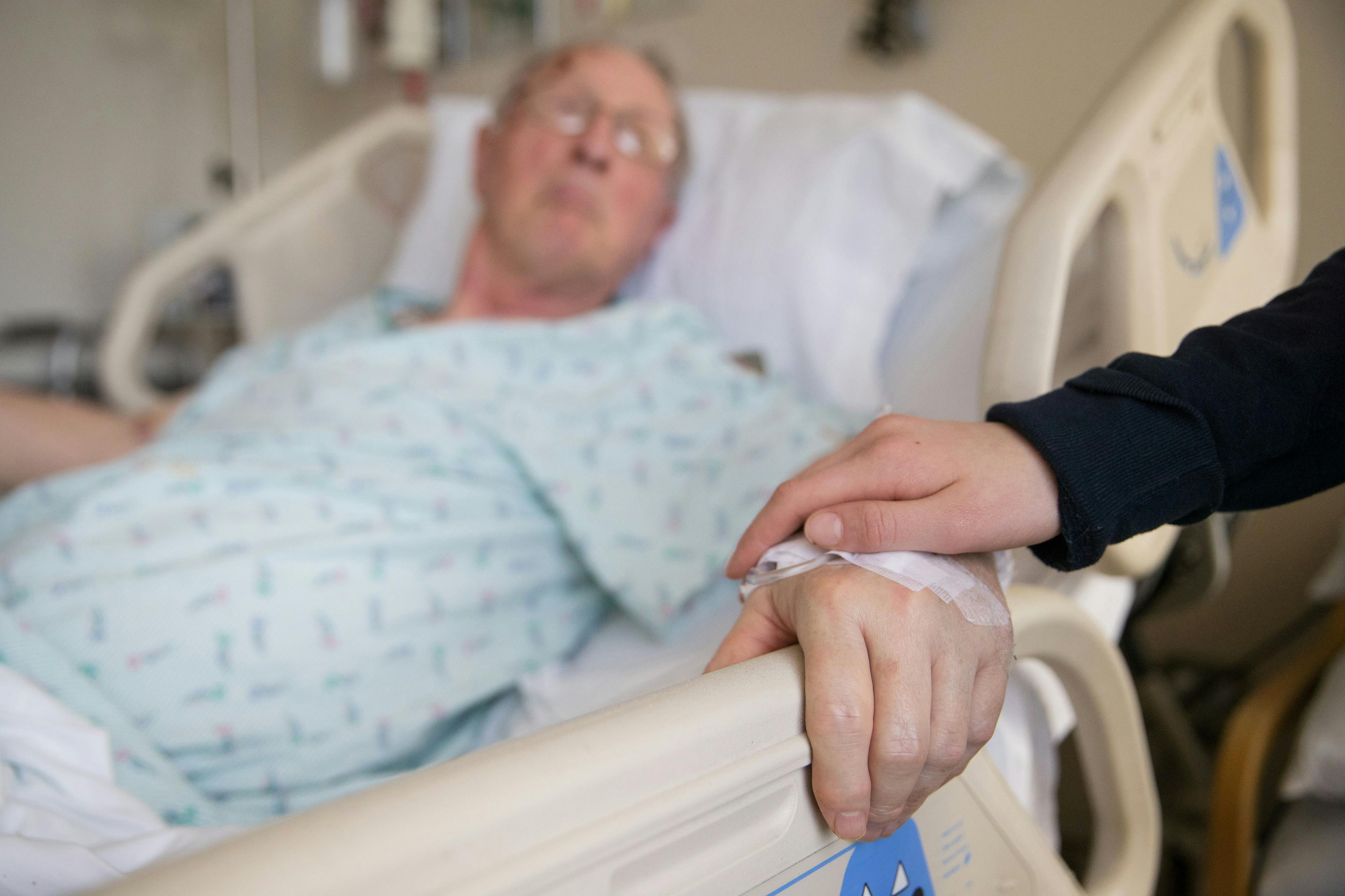 Holding hands with an elderly patient
