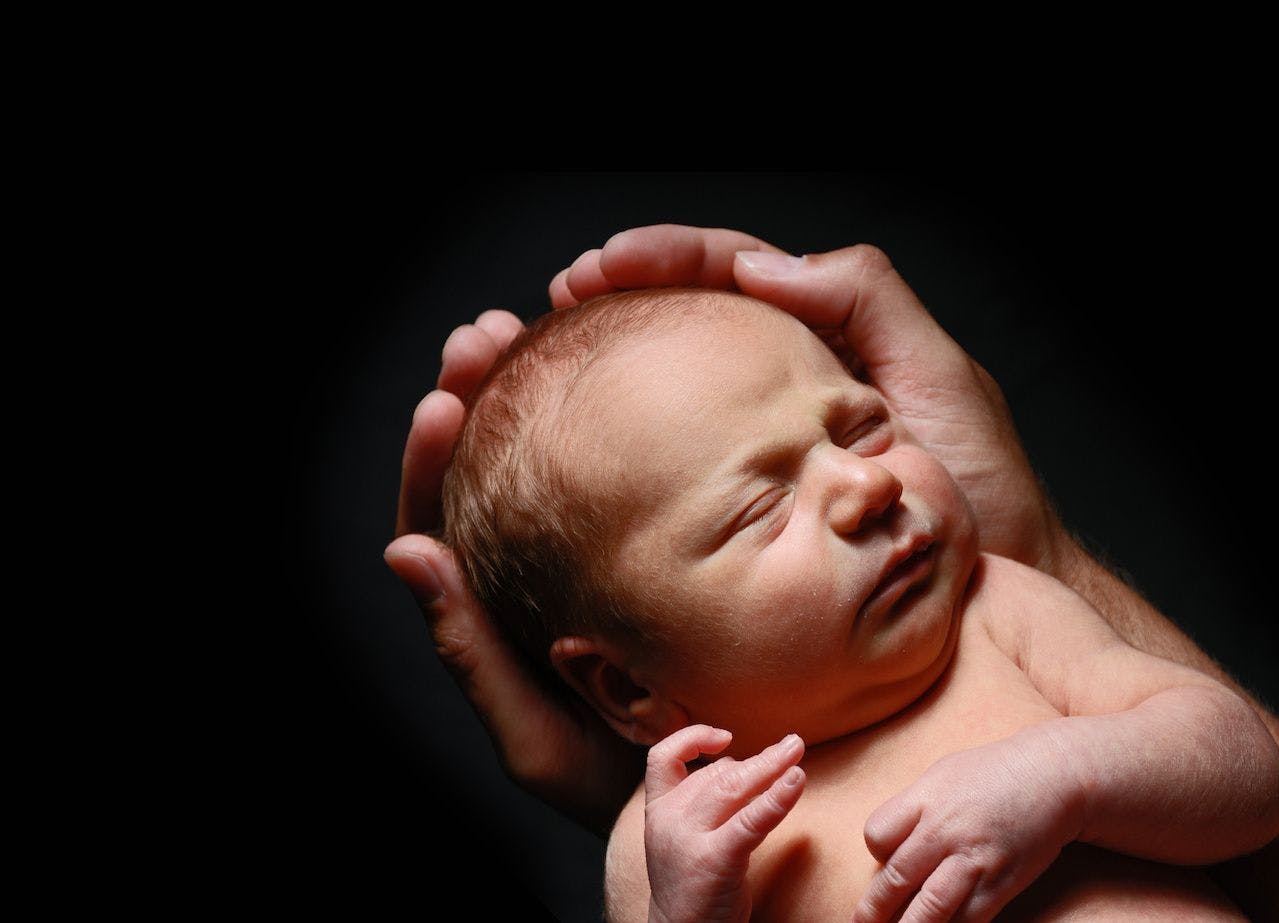 Newborn in parent hands