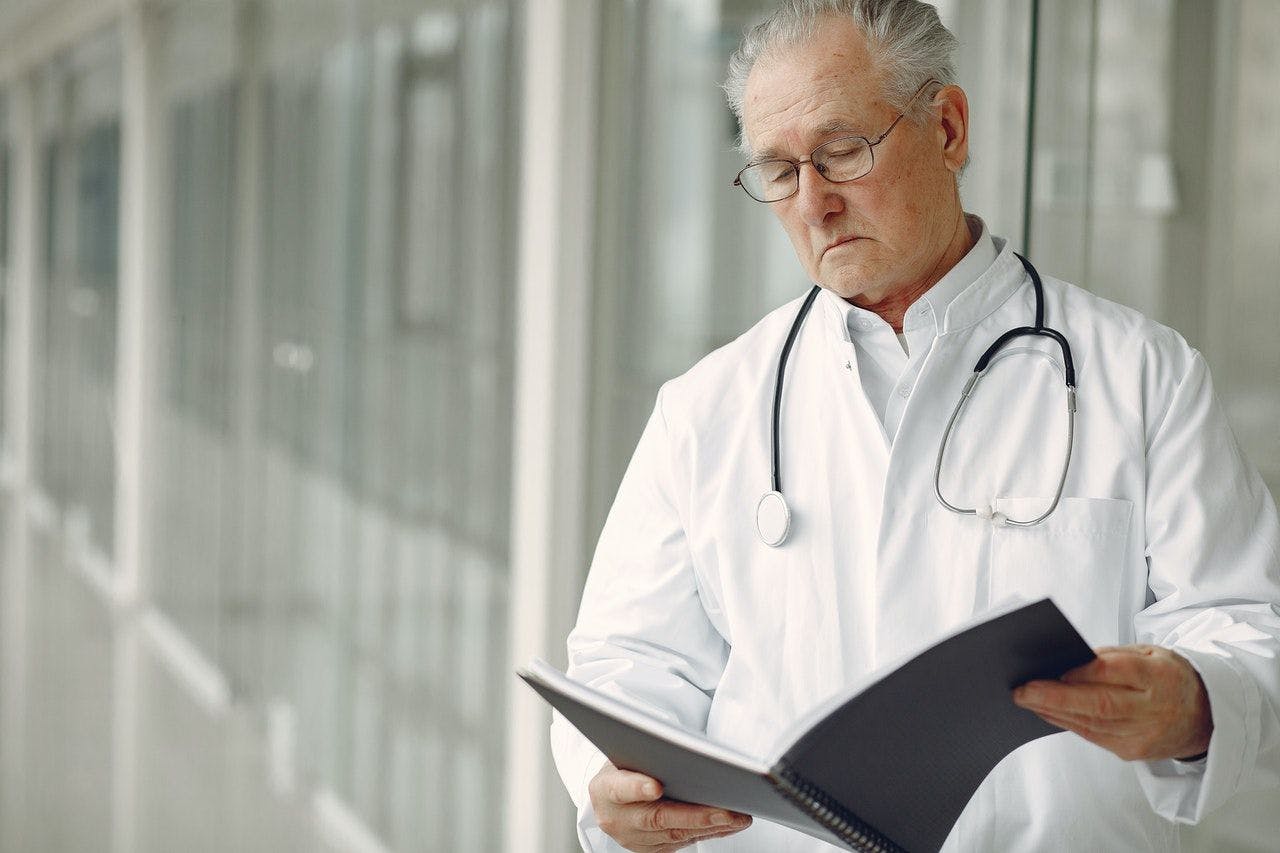 doctor looking at notes 