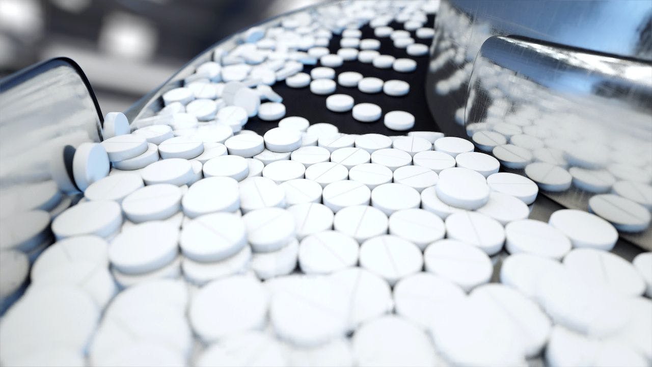 Niacin pills on conveyor belt.