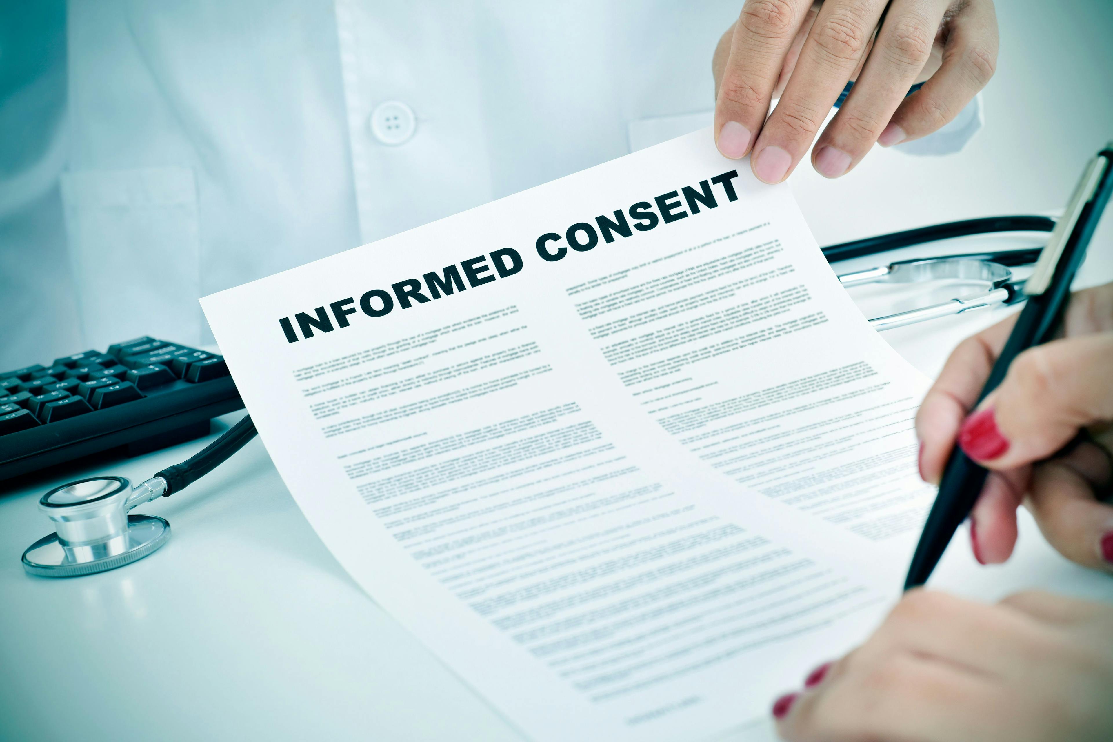 young woman signing an informed consent | nito - stock.adobe.com