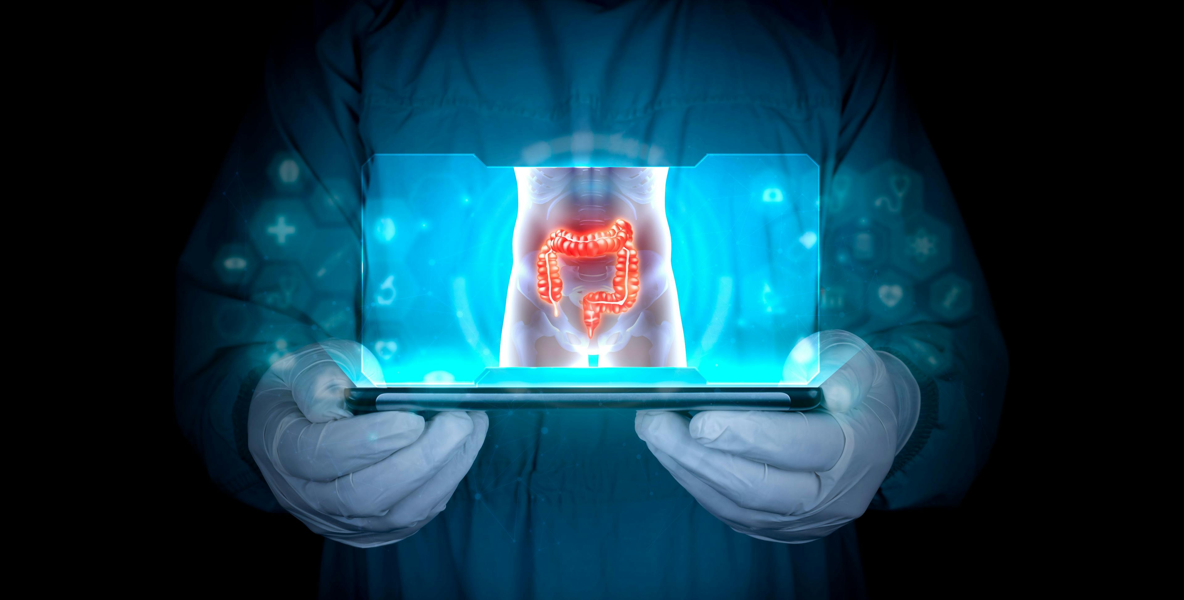 Doctor projects the human large intestine on the tablet. Study and analysis of colon cancer, bacteria, inflammation, ulcerative colitis, colonoscopy, diverticulosis. Health technology development: © Tom - stock.adobe.com